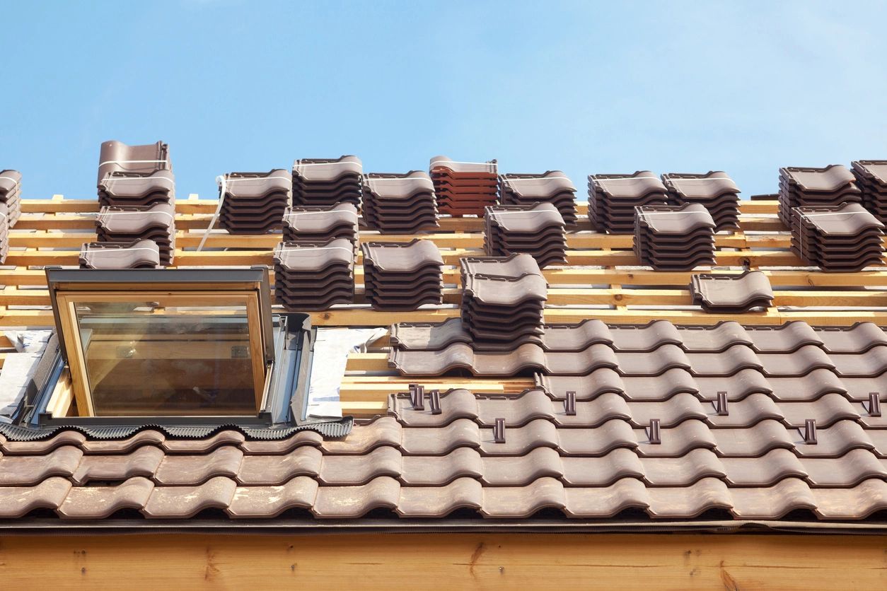 Stacks of shingles and tiles kept on a roof